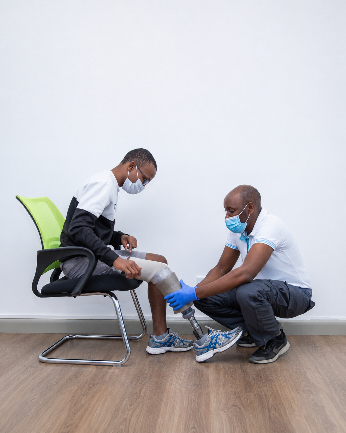 Rehabilitation professionals fitting a prosthetic leg